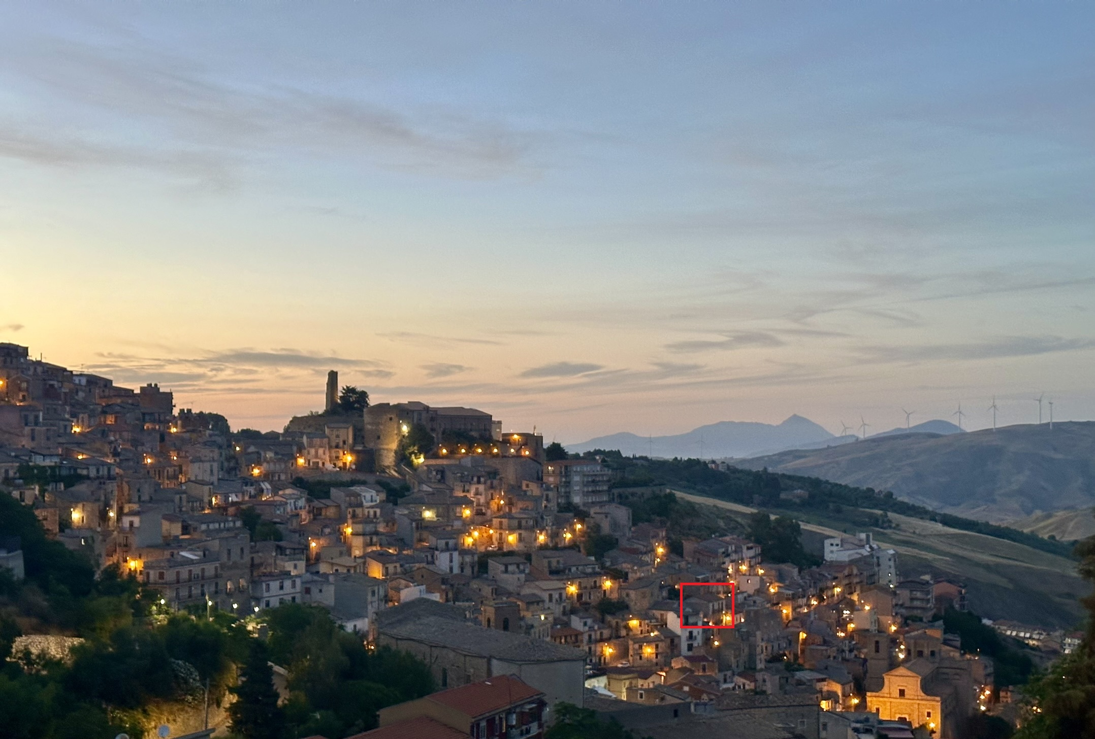 Cammarata village at dusk with the house marked